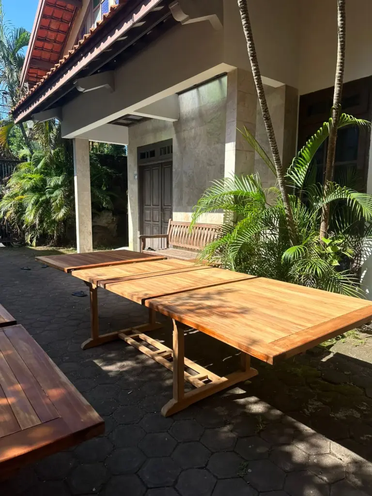 applying teak oil on outdoor furniture to maintain golden color
